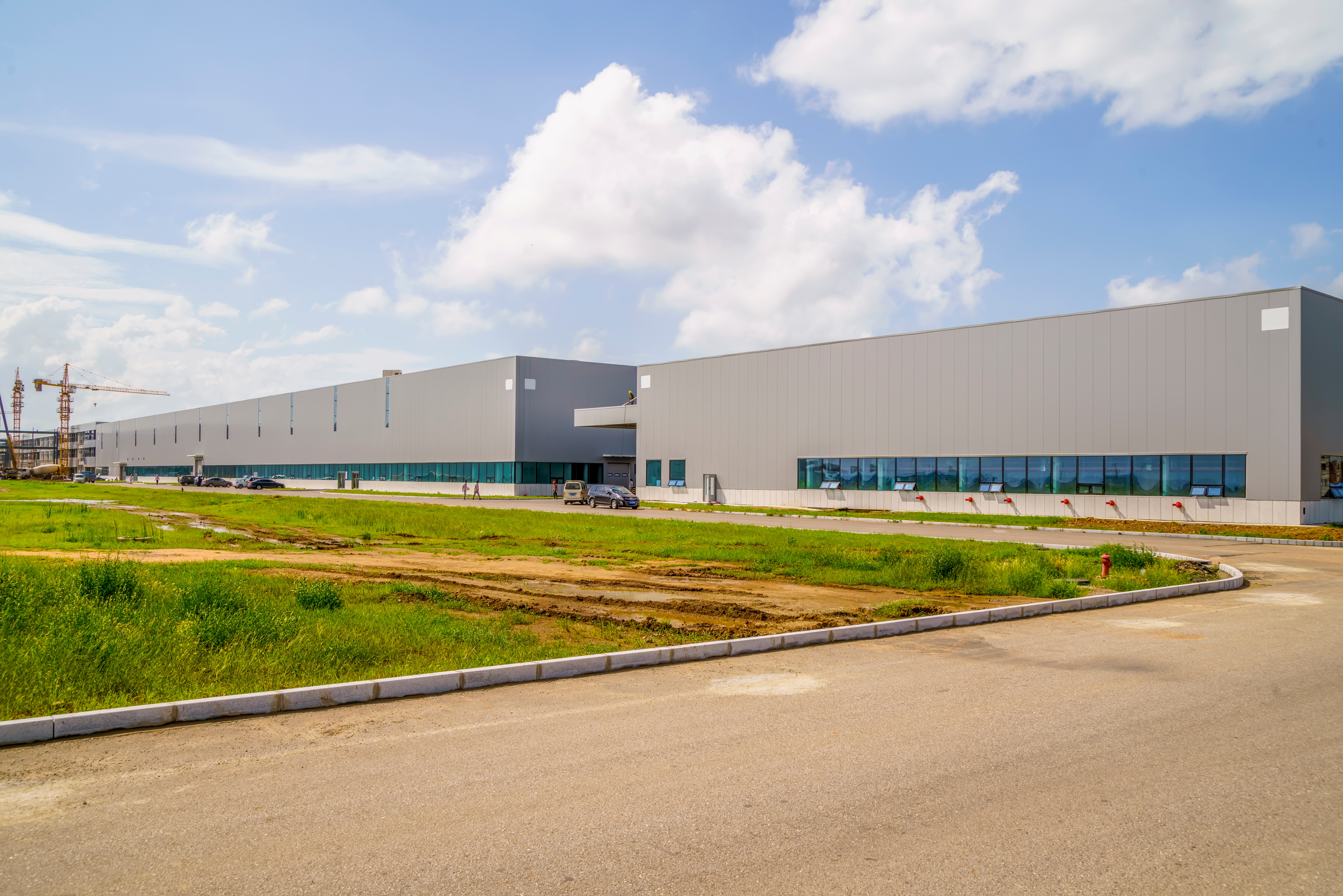 Facility side view with workers